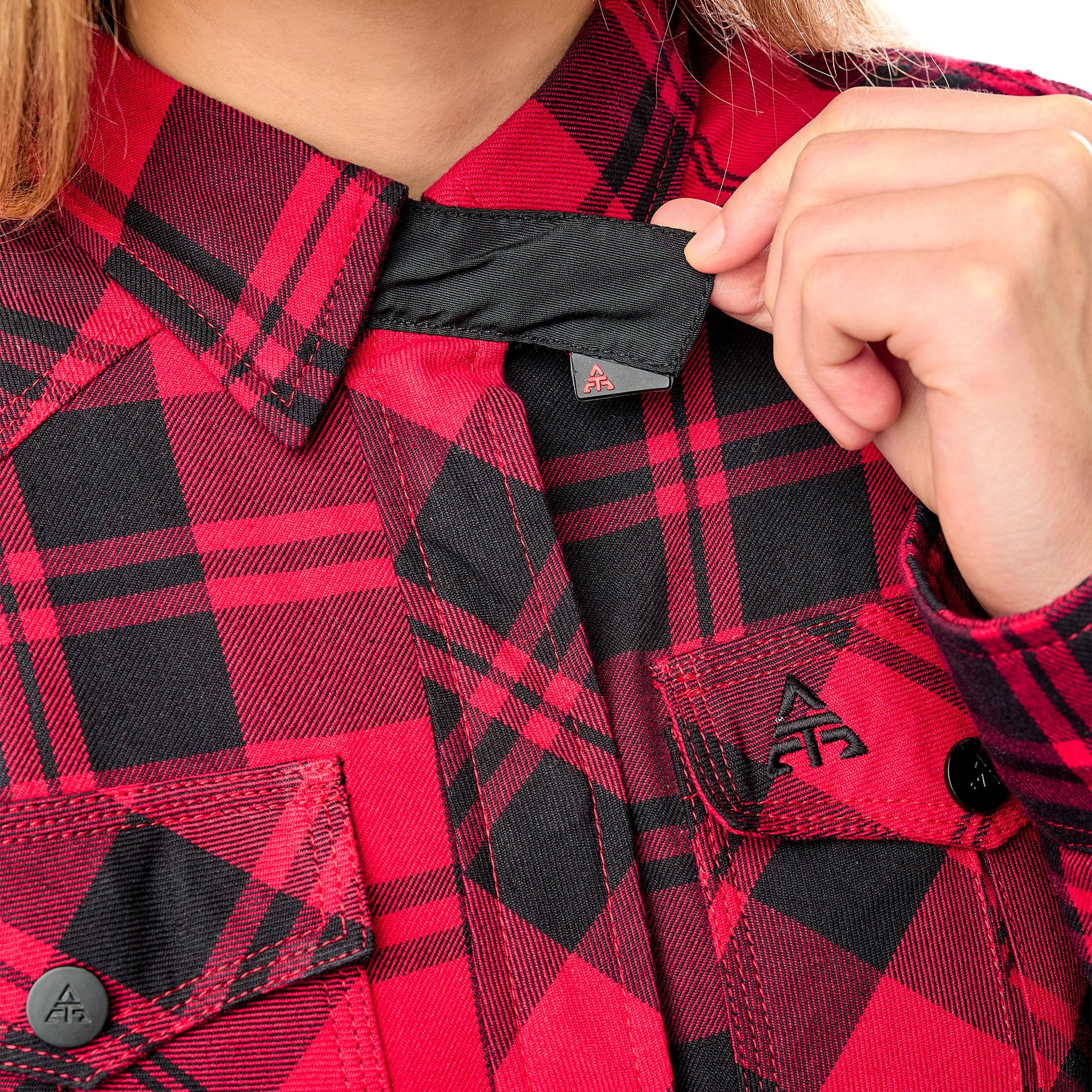 Alfa Thrust Laura Vixen – koszula motocyklowa, zbliżenie na kołnierzyk i czerwoną tkaninę w czarną kratę.